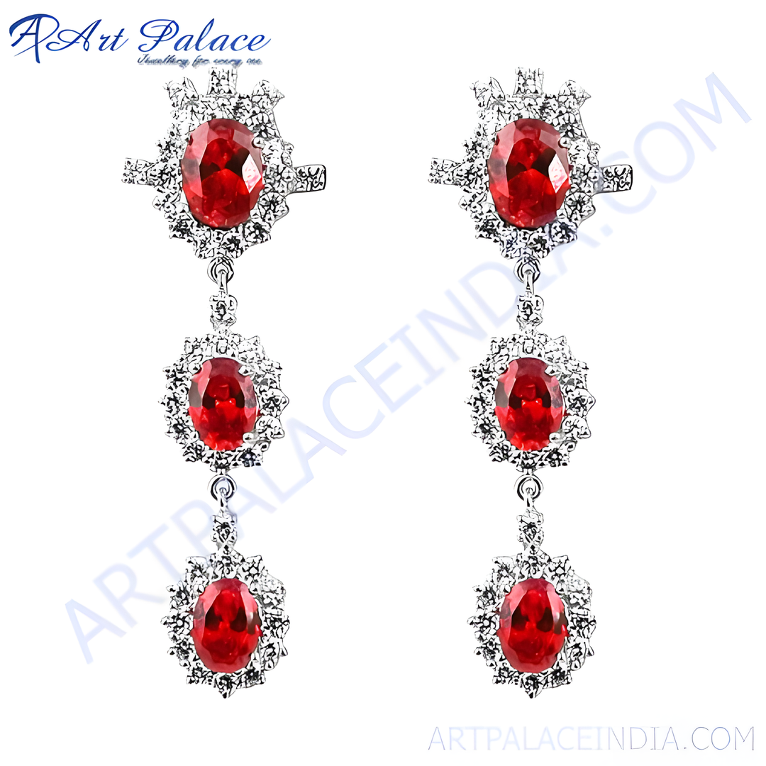 Silver drop earrings featuring vibrant red ruby gemstones.
