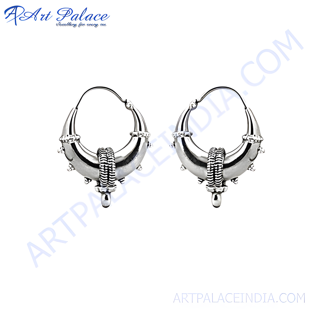 Sterling silver hoop earrings with intricate tribal design, suitable for women, showing high shine and detail.
