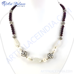 Load image into Gallery viewer, Beaded gemstone and pearl necklace on a white display. Featuring purple gemstones, pearls, and silver accents.
