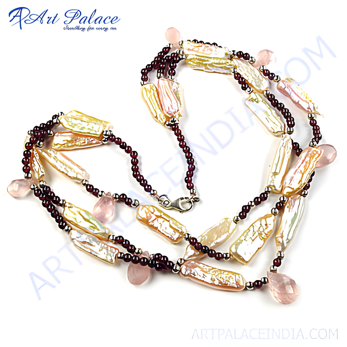 Garnet and pearl necklace featuring a variety of pearl shaped gems and vibrant red garnet beads, set against a white backdrop