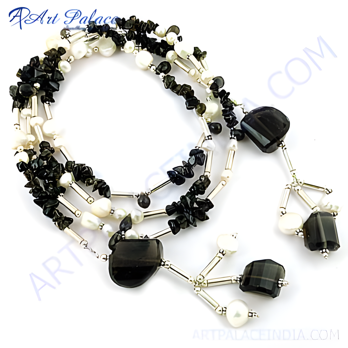 Sterling silver necklace featuring black onyx and white pearls on a white background