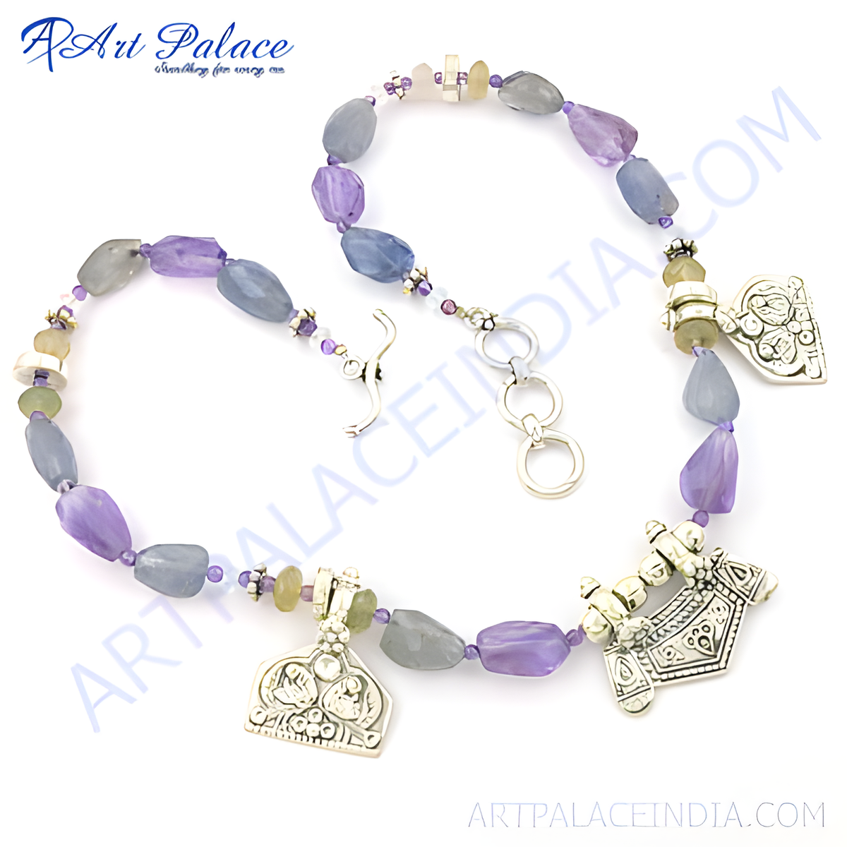 A close up of a gemstone beaded necklace with purple and gray beads on a white background