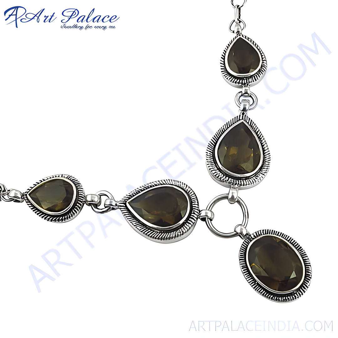 Sterling silver necklace featuring smoky quartz gemstones in a teardrop design, set against a white background.