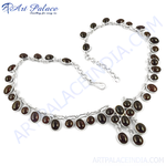 Load image into Gallery viewer, 925 sterling silver necklace with oval-shaped garnet gemstones on a white background.
