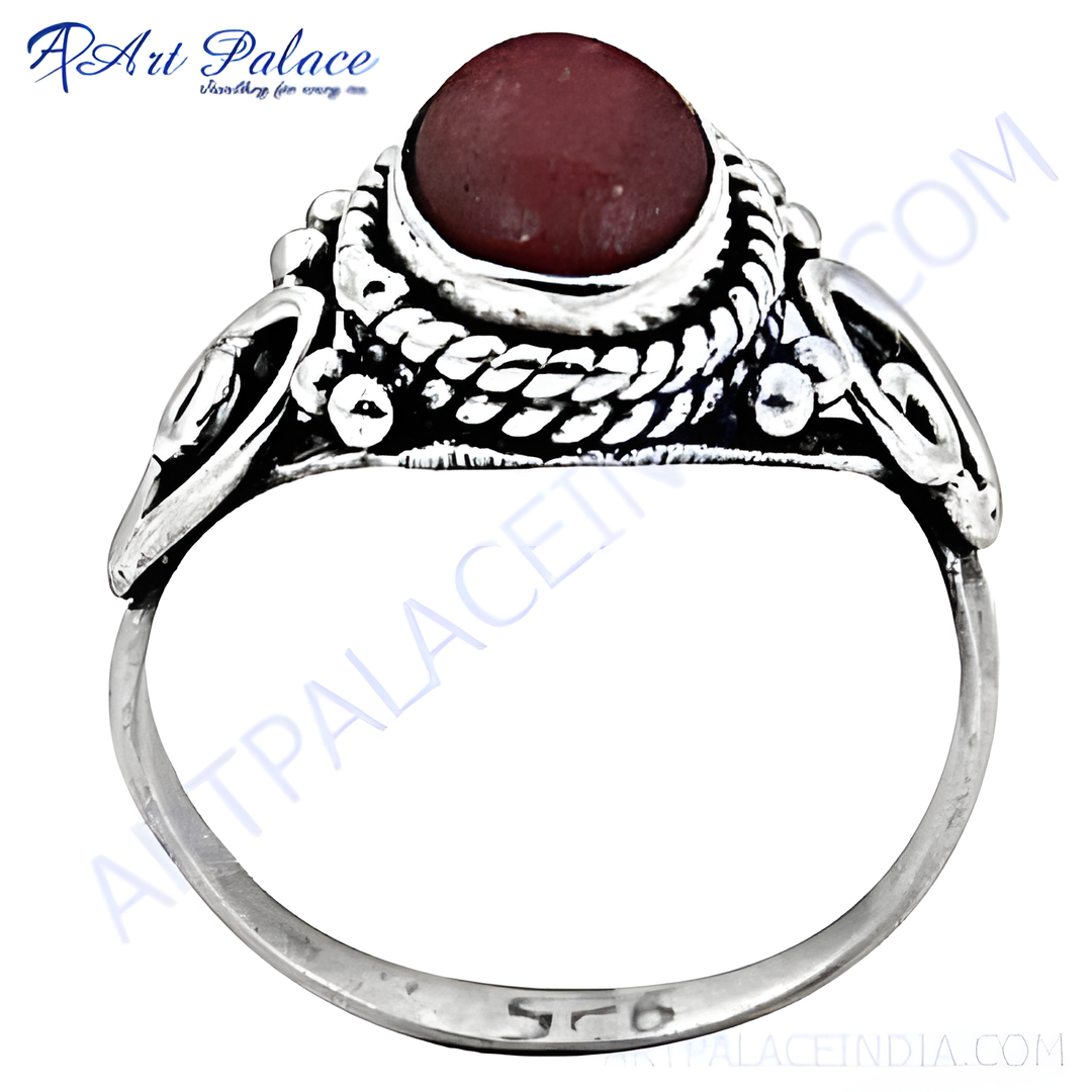 Sterling silver ring with a vibrant red garnet gemstone center, ideal for women's fashion.