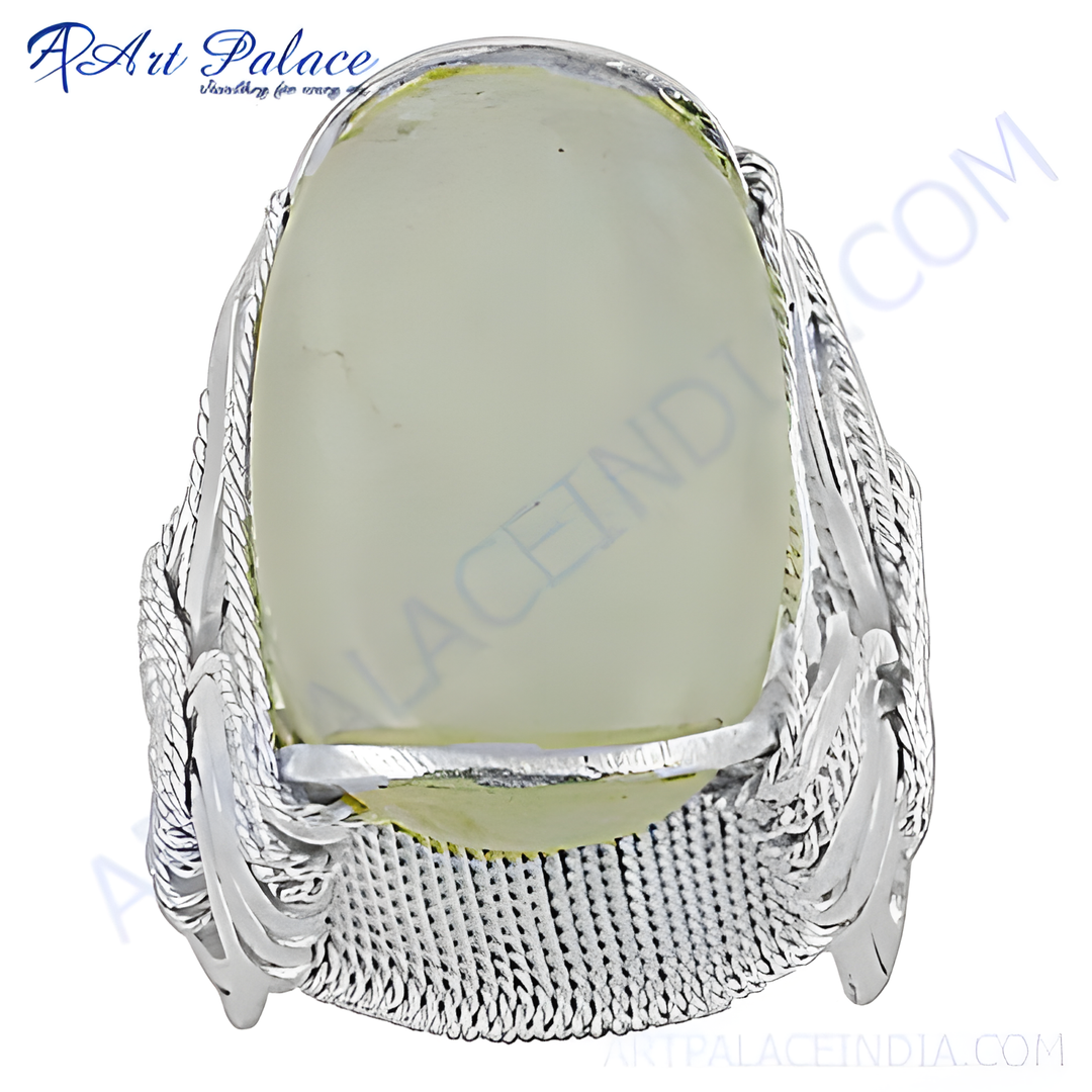 Sterling silver ring with a large, oval-shaped pale green gemstone. Modern design for women.