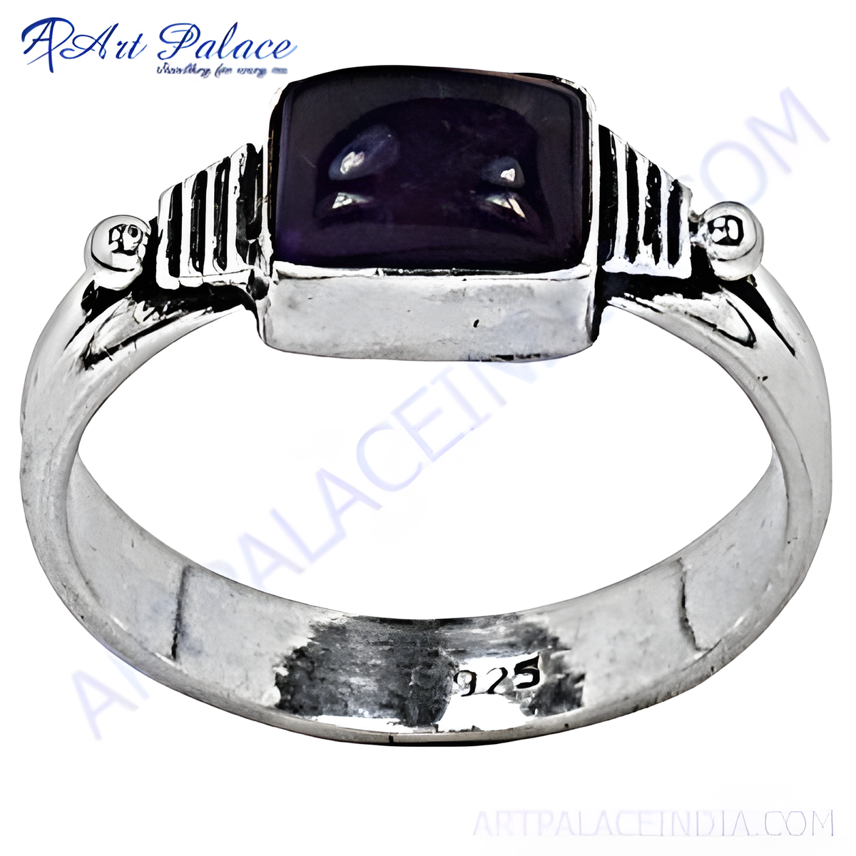 A sterling silver ring with a rectangular amethyst gemstone center in a close up shot