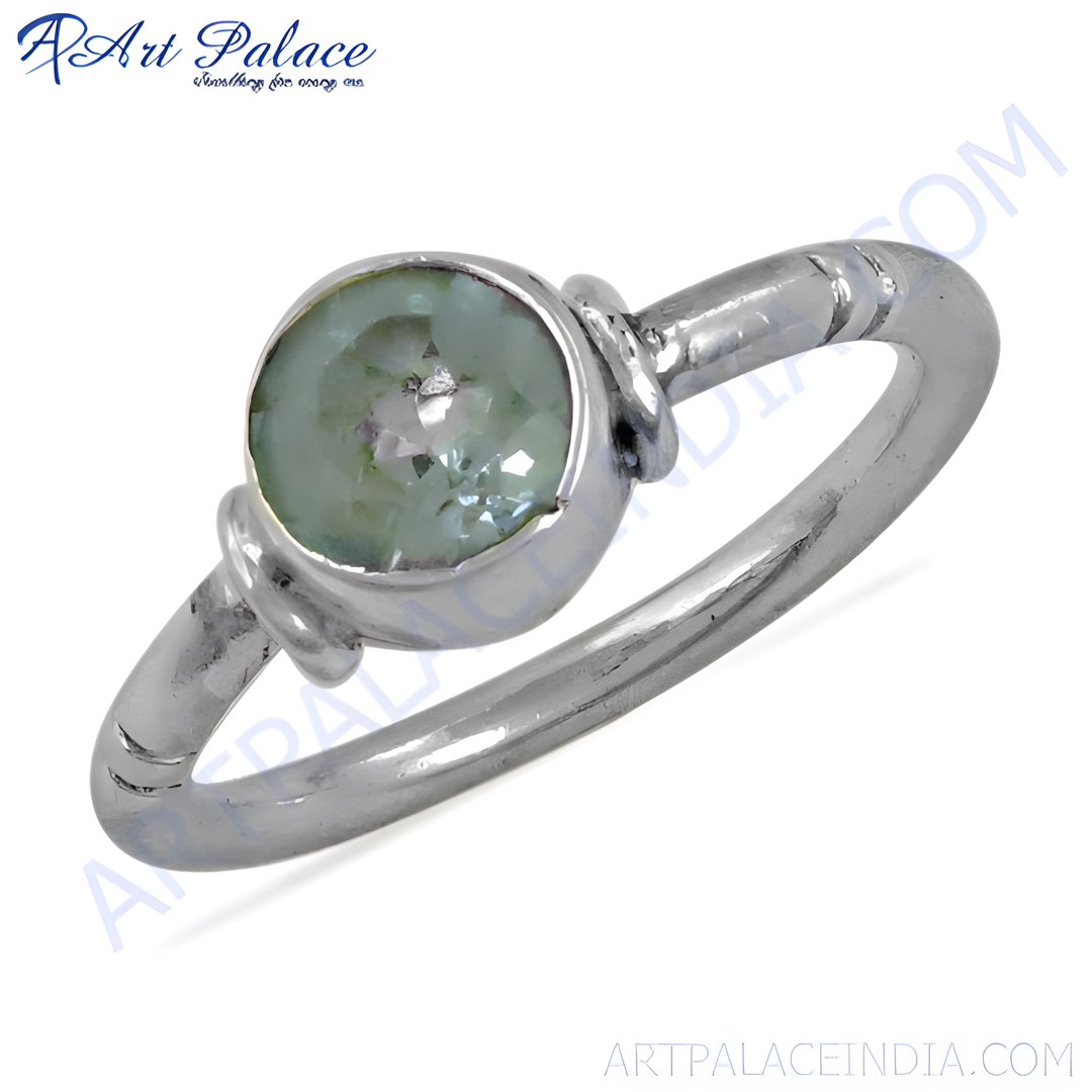 Sterling silver ring with a round, green gemstone set in a knot design.