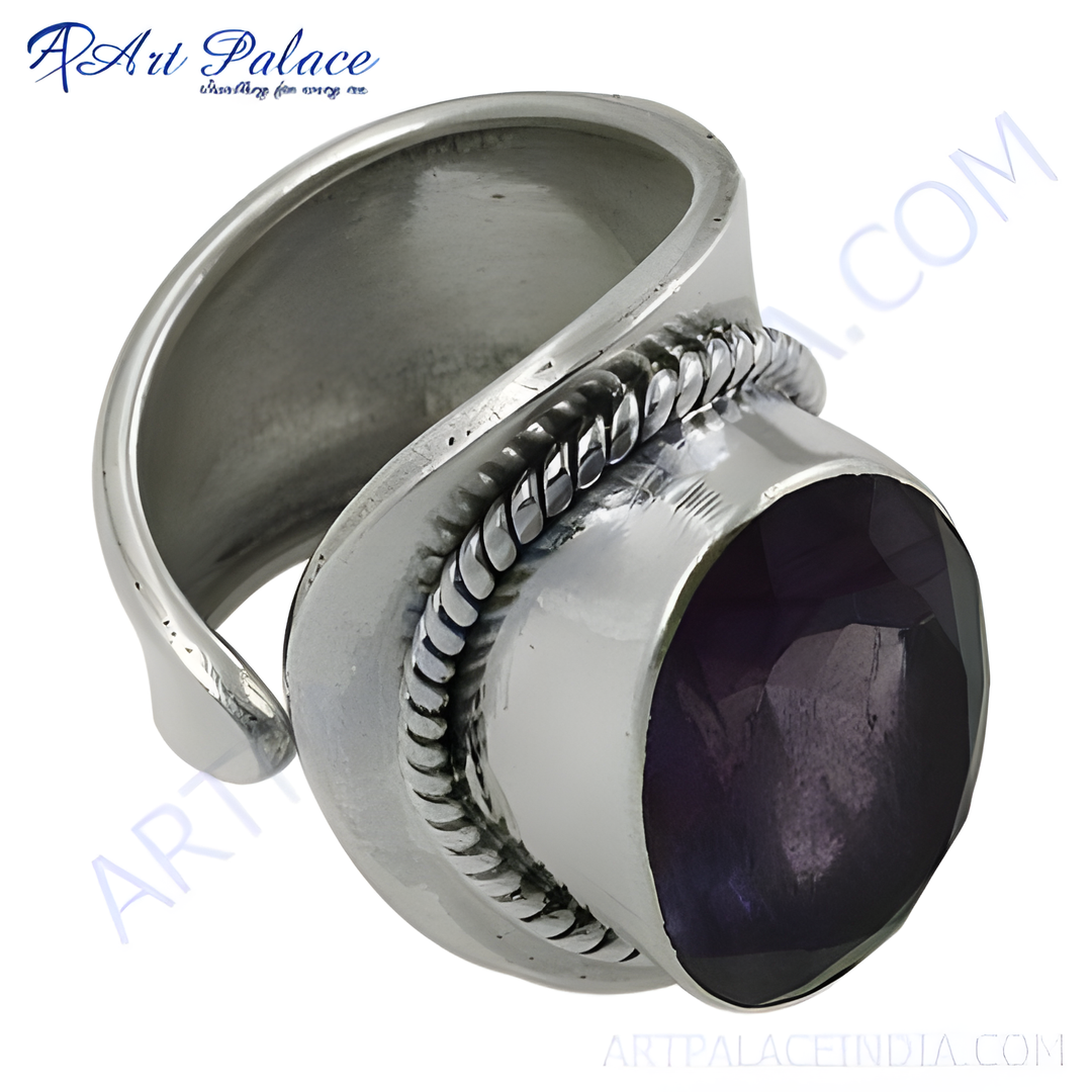 Sterling silver ring with a large, oval-cut amethyst gemstone. The purple stone is set in a polished silver band.