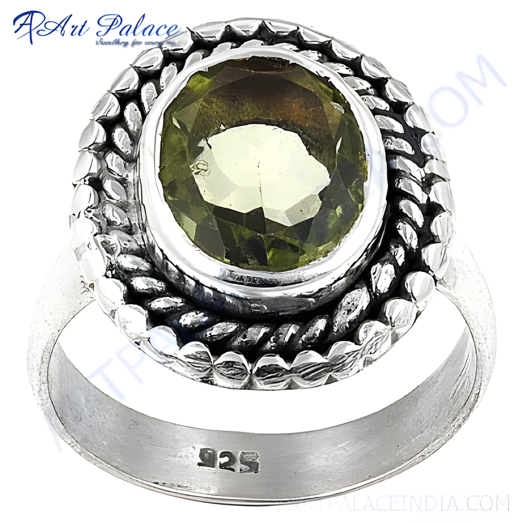 Sterling silver ring with a large, round green peridot gemstone, showcasing a detailed design around the stone.