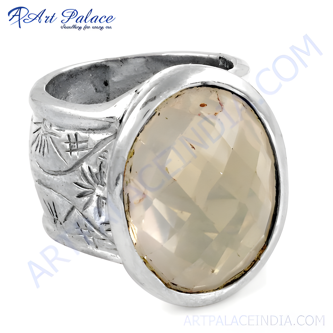Silver statement ring with oval gemstone. Features a polished silver band with a faceted light-colored gemstone, perfect for women.