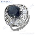 Load image into Gallery viewer, Sterling silver cocktail ring featuring a dark blue sapphire center stone and white CZ accents.
