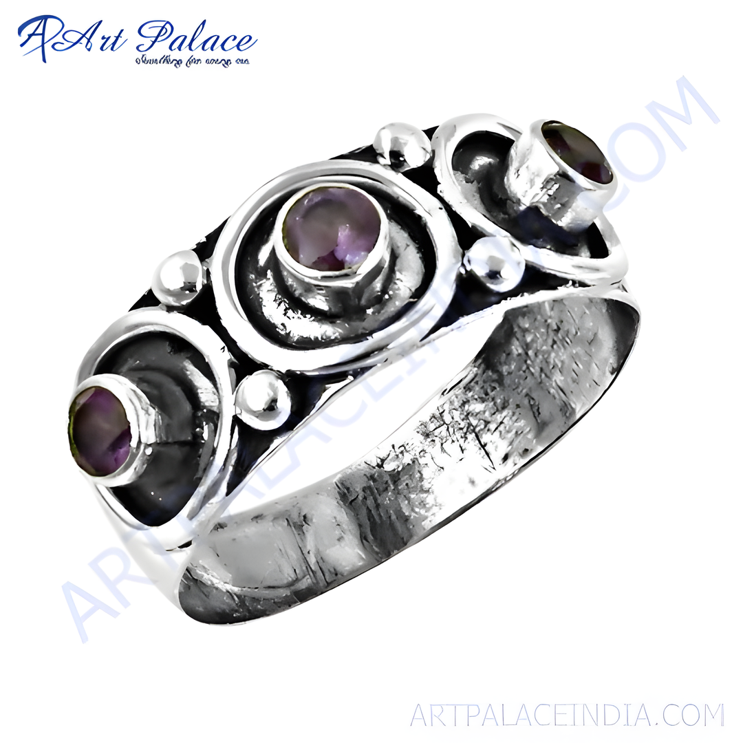Sterling silver ring with three oval amethyst stones, set in a unique design.