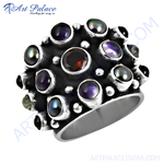 Load image into Gallery viewer, Sterling silver cocktail ring with round black and purple gemstones and a central garnet stone.
