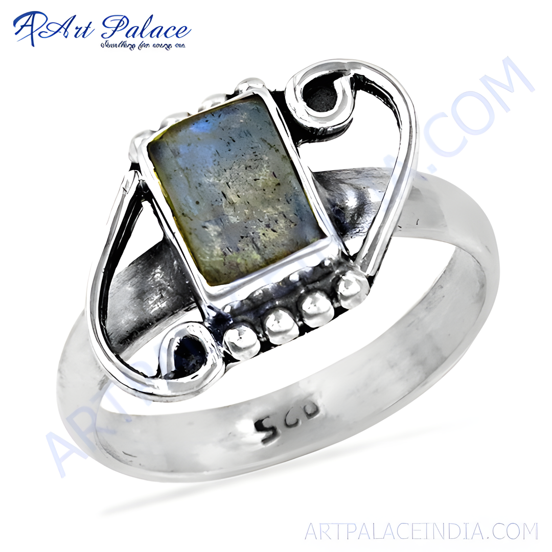 Sterling silver ring with a rectangular labradorite gemstone, showcasing a play of blue and grey colors.