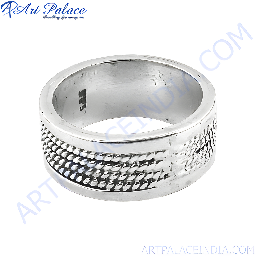 Sterling silver textured ring with a detailed design on a white background, showcasing the ring's polished finish and craftsmanship