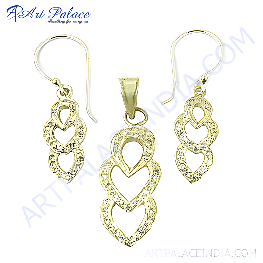 gold plating pendant and earrings set with crystal heart design on white background