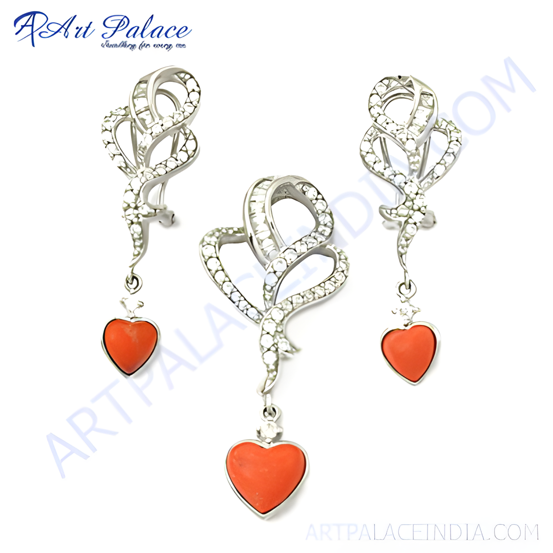 Silver pendant and earring set featuring heart-shaped coral gemstones.