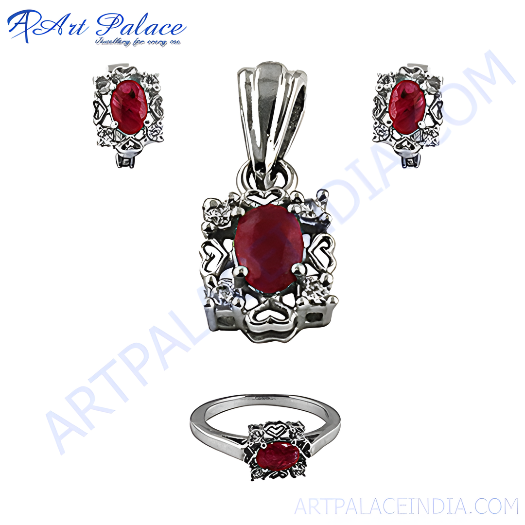 A stunning silver jewelry set featuring a ruby gemstone pendant, matching earrings, and a ring.
