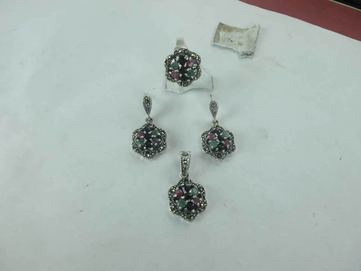 Sterling silver gemstone ring and earrings set with red, green, and black stones