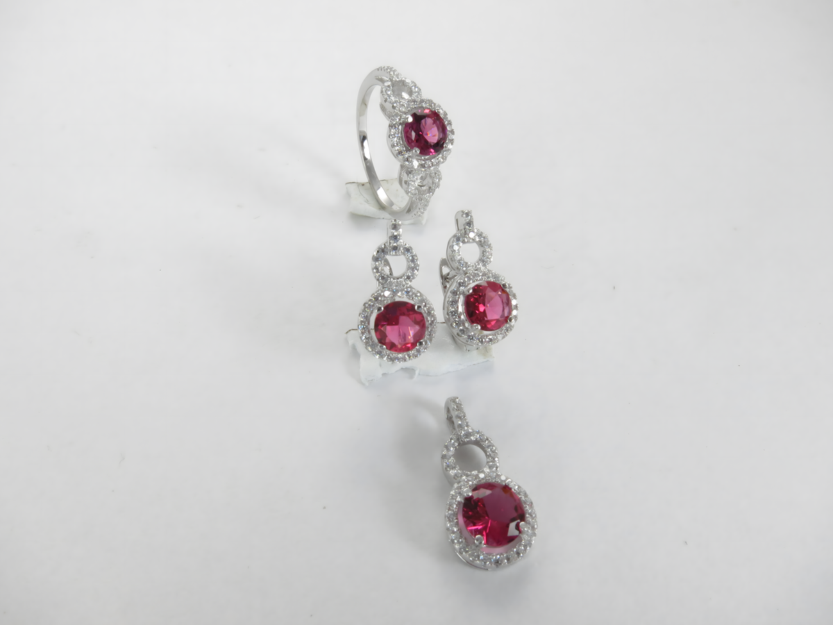 Silver ring, earrings, and pendant jewelry set featuring red ruby gemstones