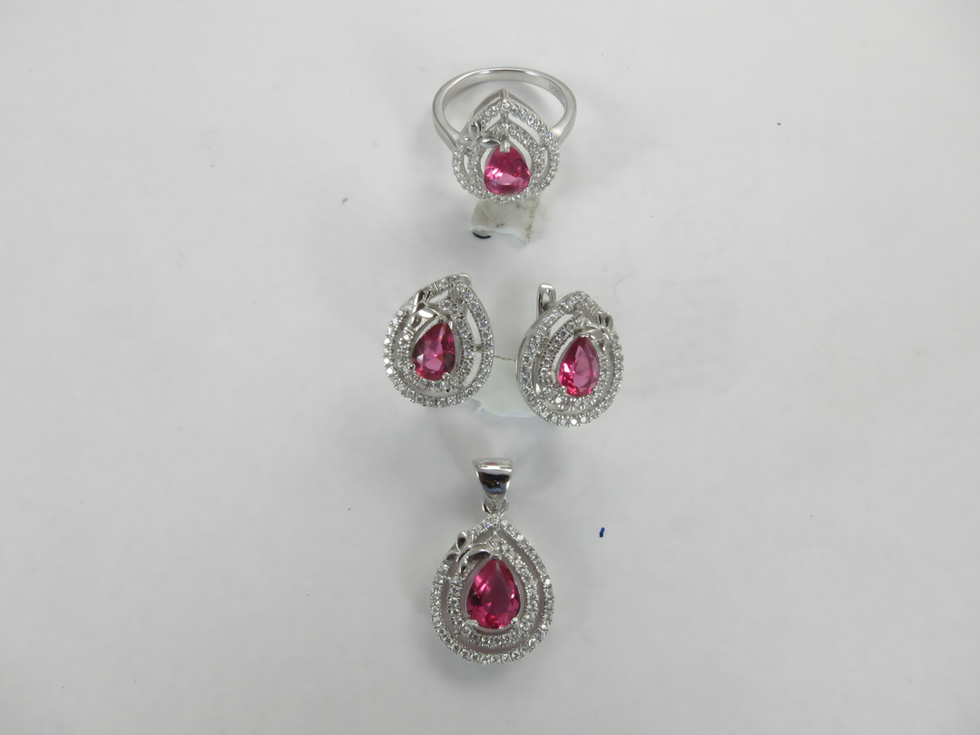 Silver ruby jewelry set, featuring a ring, earrings and pendant with pink gemstones.