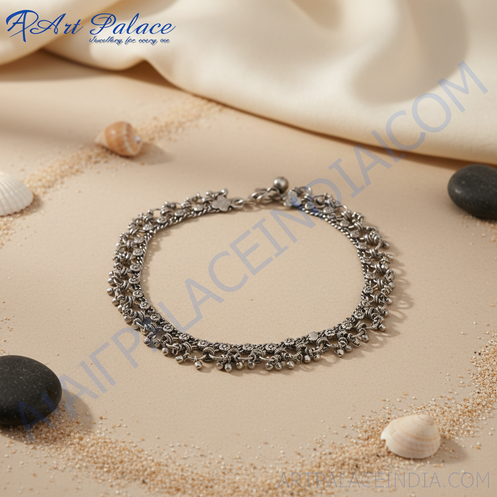 Oxidized silver anklet with intricate vintage design on white background