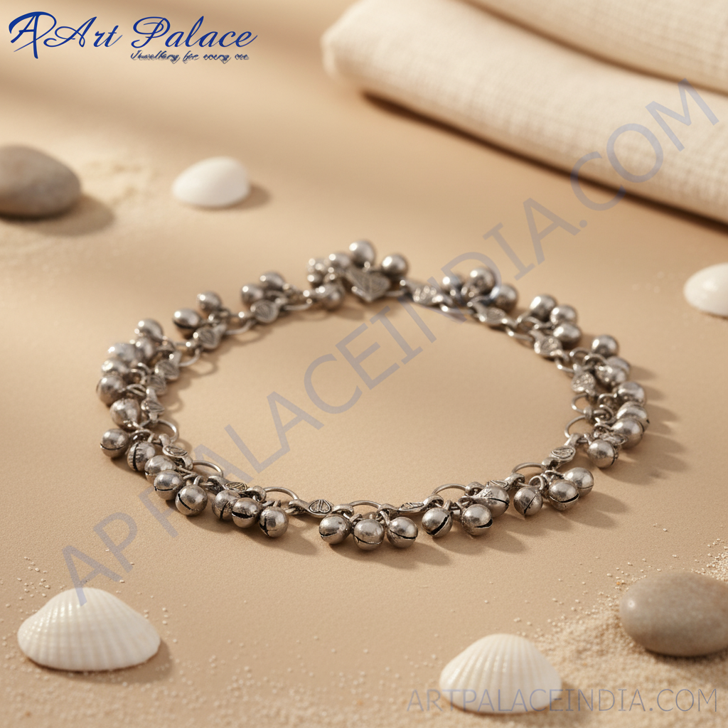 Silver anklet with dangling bells on a white background, perfect for women's fashion and accessories.