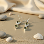 Load image into Gallery viewer, Sterling silver dangle earrings with pear-shaped green gemstones, perfect for a special gift.
