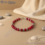 Load image into Gallery viewer, Red beaded necklace on a black jewelry display, showcasing the vibrant red beads and silver accents.
