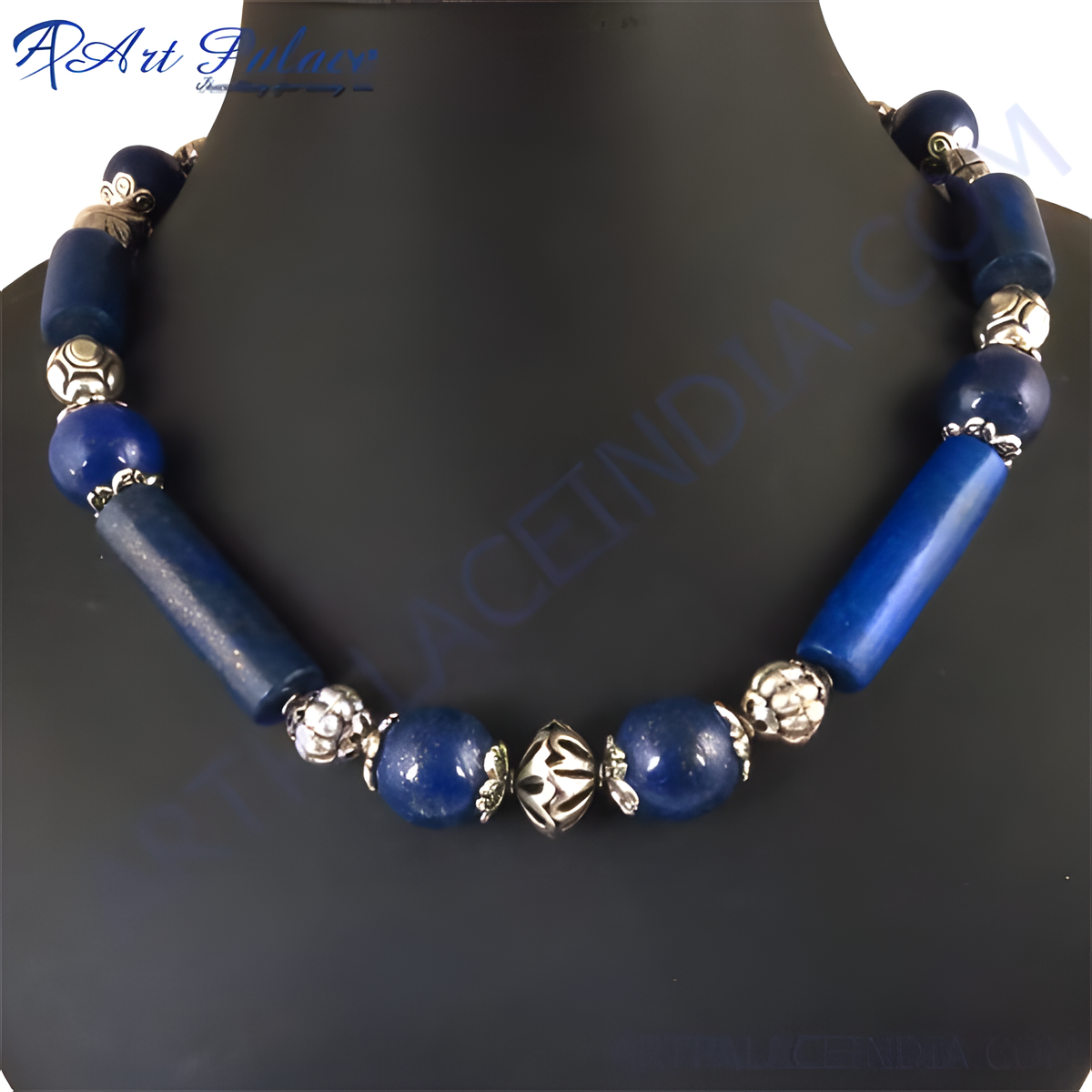 Blue gemstone beaded necklace displayed on a black mannequin, featuring a variety of bead shapes and silver accents