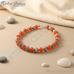 Load image into Gallery viewer, Red carnelian bead necklace with sterling silver accents on a black display.
