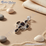 Load image into Gallery viewer, 925 sterling silver pendant with black gemstones set in a unique floral design.
